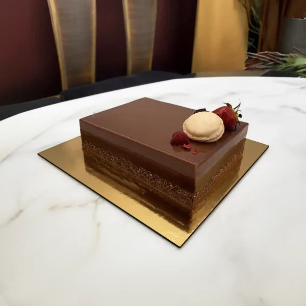 A Passion Mousse Cake, a delectable creation from Pierre and Michel Bakery, available in Somerville, Ridgewood, Upper Saddle River, and Elmwood Park, NJ