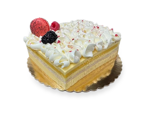 A slice of French Exotic cake, featuring layers of light sponge cake, tropical fruit filling, and a delicate whipped cream topping.