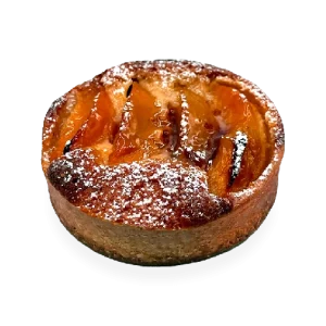 Scrumptious French tart with a buttery crust, filled with juicy peach slices, and garnished with a sprinkle of powdered sugar. Pierre and Michel your authentic French bakery
