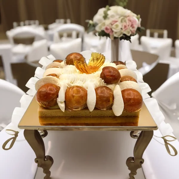 A Saint Honoré Cake, a delectable creation from Pierre and Michel Bakery, available in Somerville, Ridgewood, Upper Saddle River, and Elmwood Park, NJ