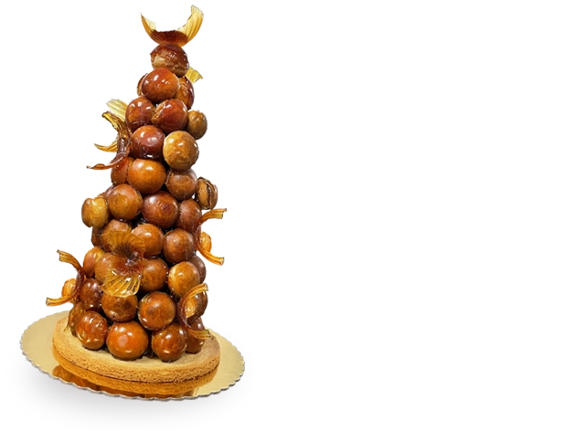 A towering Croquembouche Cake, a masterpiece of French pastry artistry, adorned with spun sugar and filled with luscious cream-filled profiteroles.