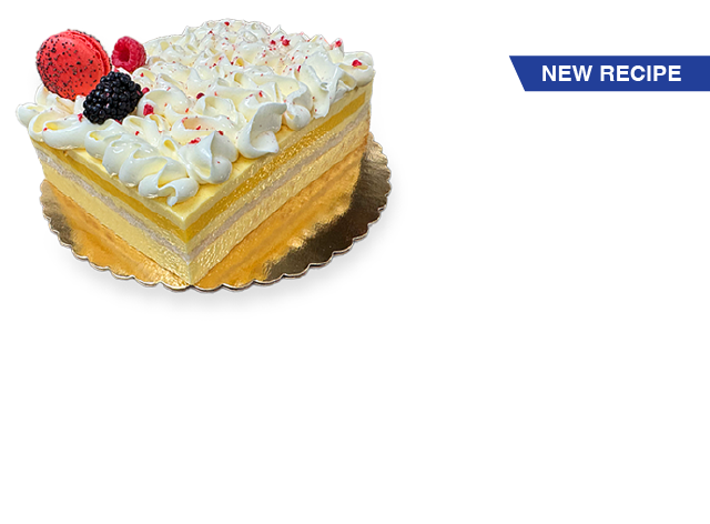 A slice of French Exotic cake, featuring layers of light sponge cake, tropical fruit filling, and a delicate whipped cream topping.