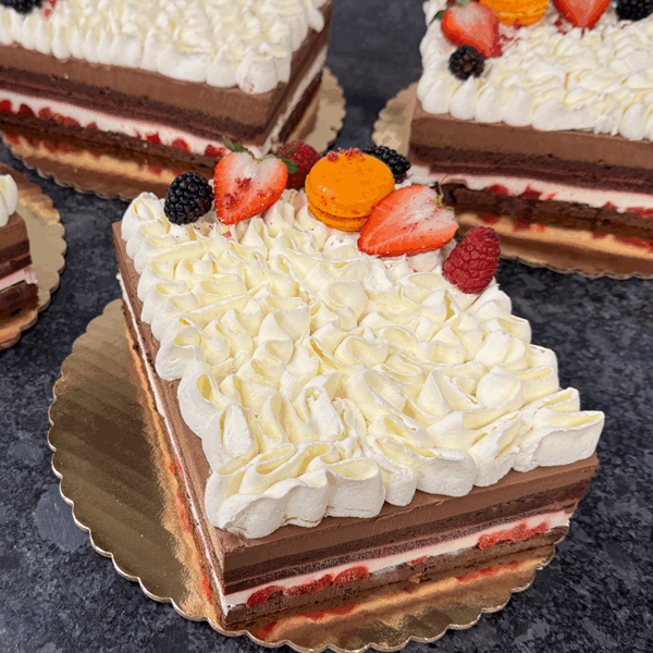 Pierre & Michel Black Forest cake topped with Chantilly cream and cherries