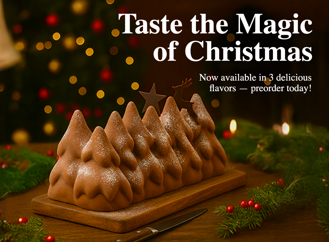 Handcrafted Christmas Cake (Bûche de Noël) made with premium ingredients, topped with festive decorations, freshly prepared in New Jersey French bakery.